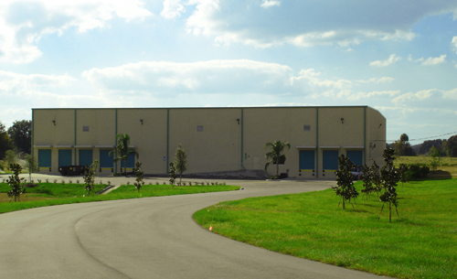 a building with trees and grass